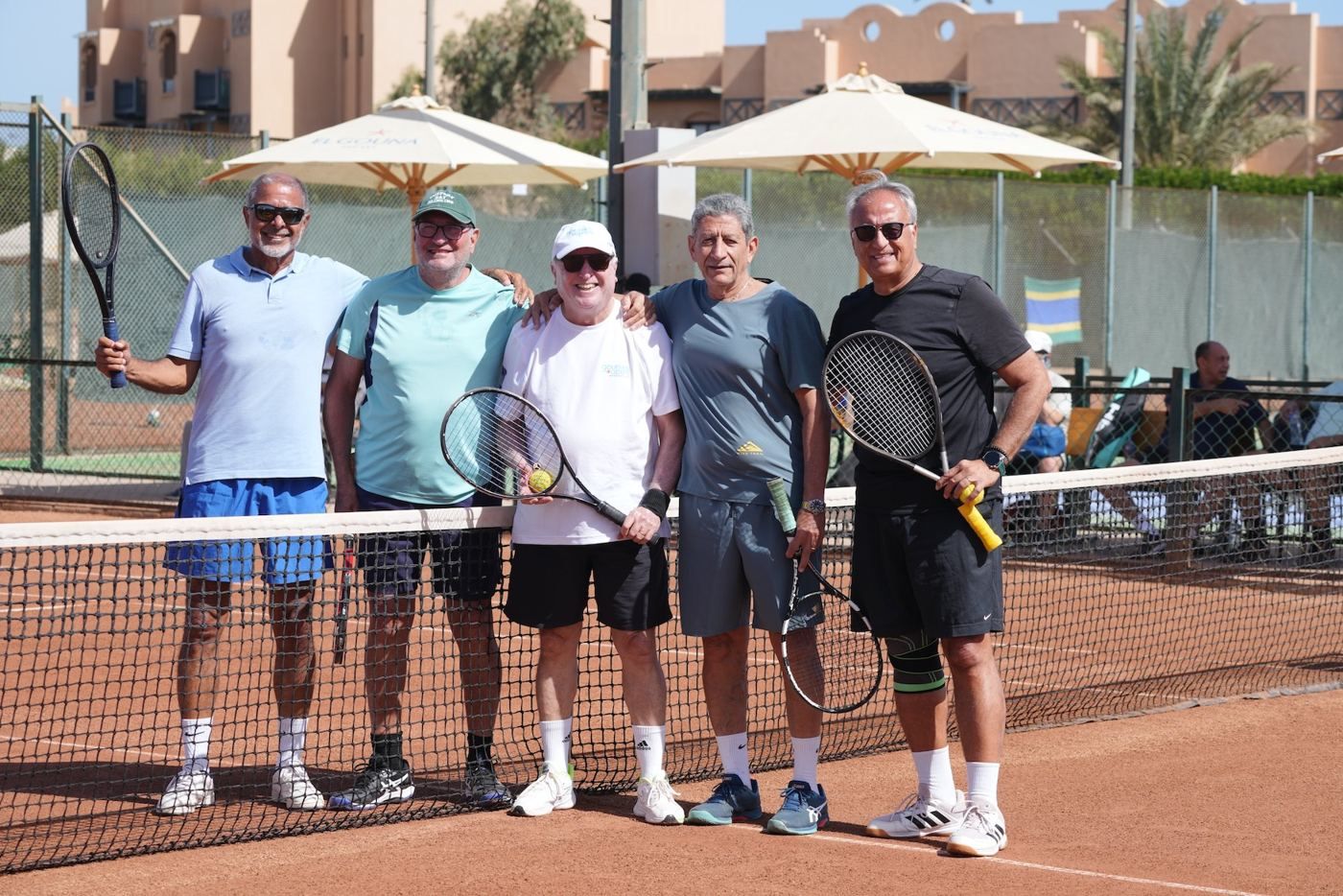 Players smiling at the net at the 13th Gezira Senior Classic